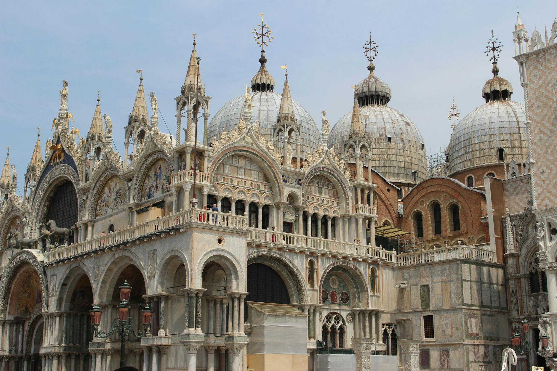 Detailed exterior facade and domes of a historic ornate cathedral with statues and arches