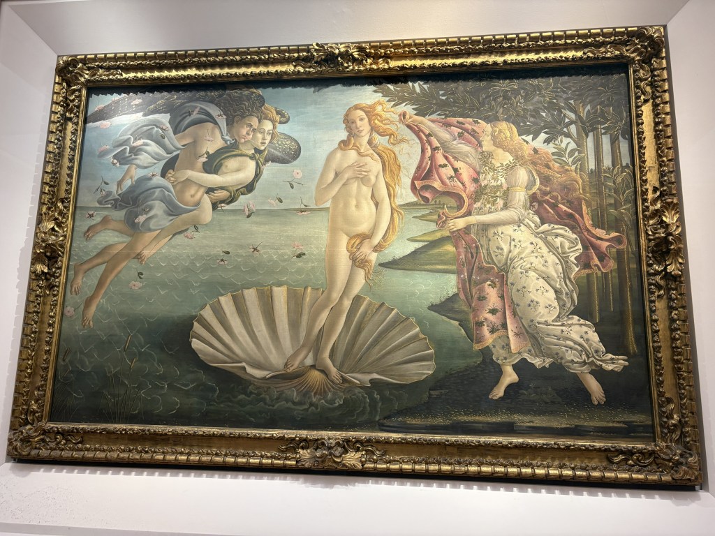 A classical painting depicting Venus emerging from a shell, surrounded by mythological figures, with a landscape background.